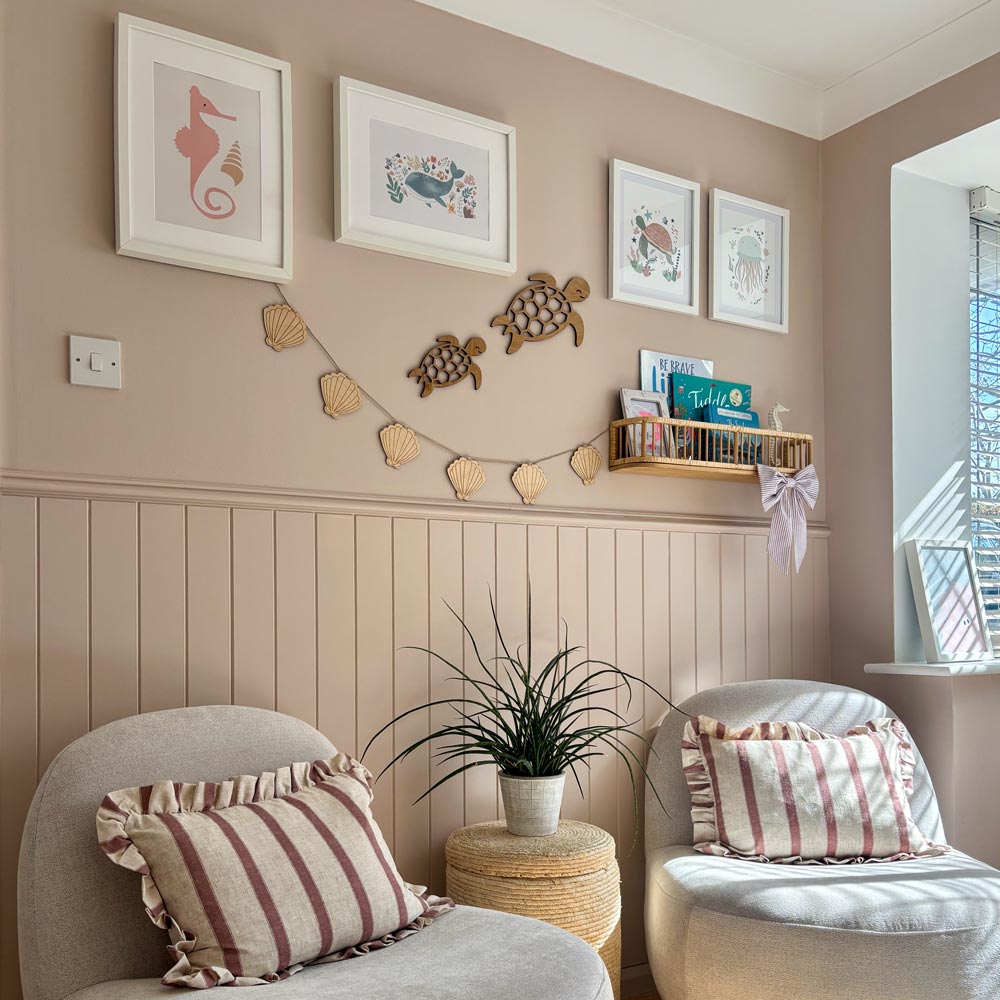 A cosy neutral playroom corner featuring custom height V-groove wall panelling painted in Farrow & Ball Scallop.