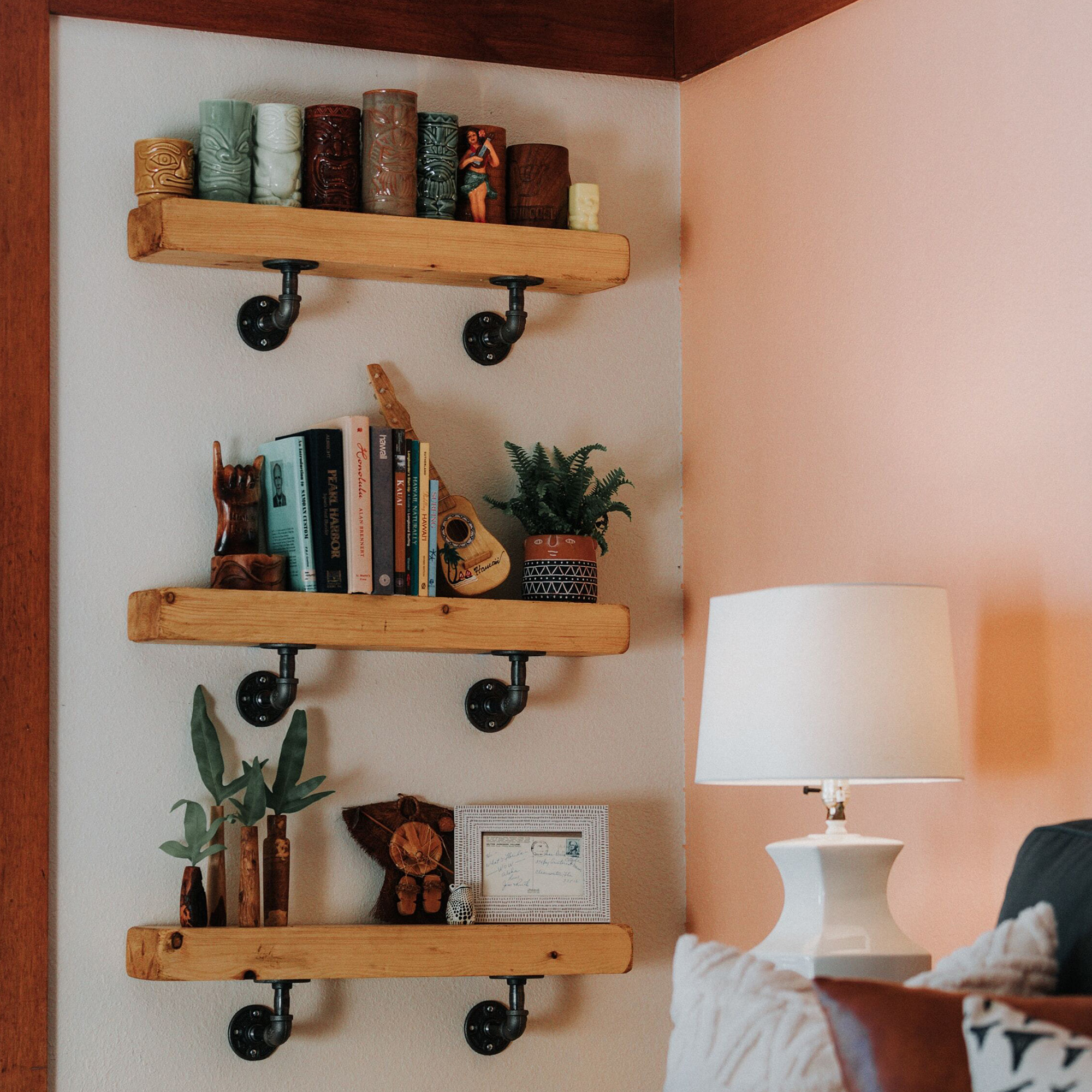 Pipe shelves mounted on wall