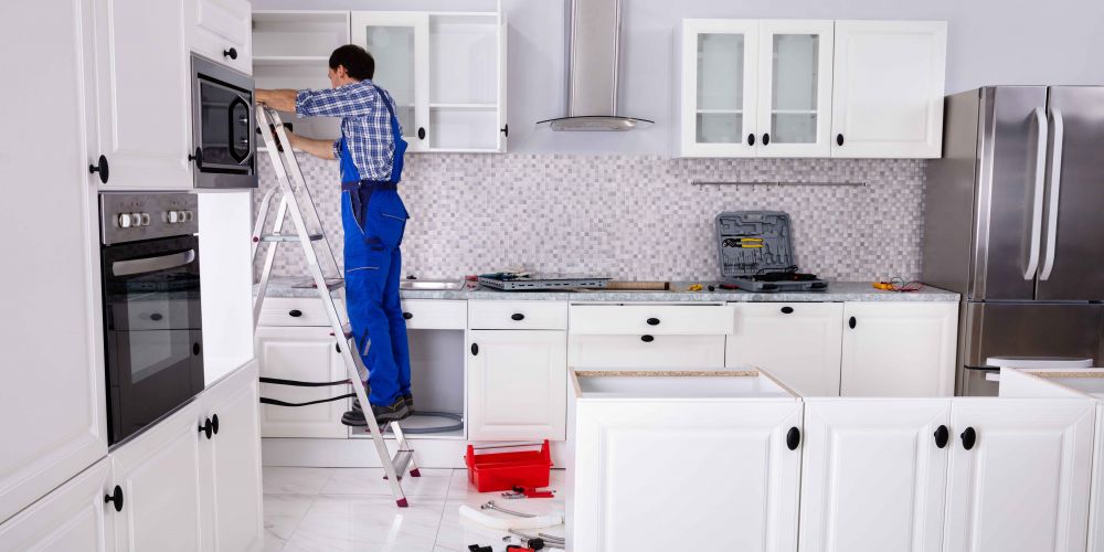 man installing kitchen doors