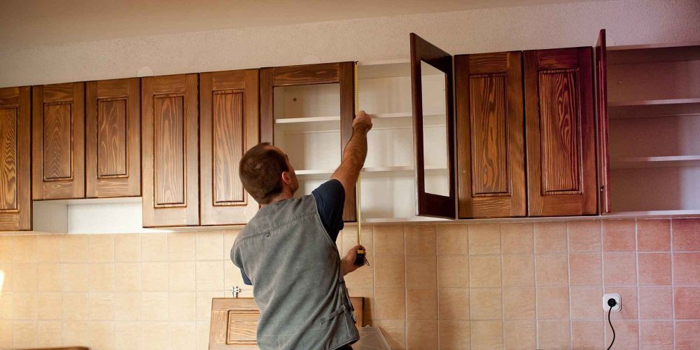 man measuring kitchen door