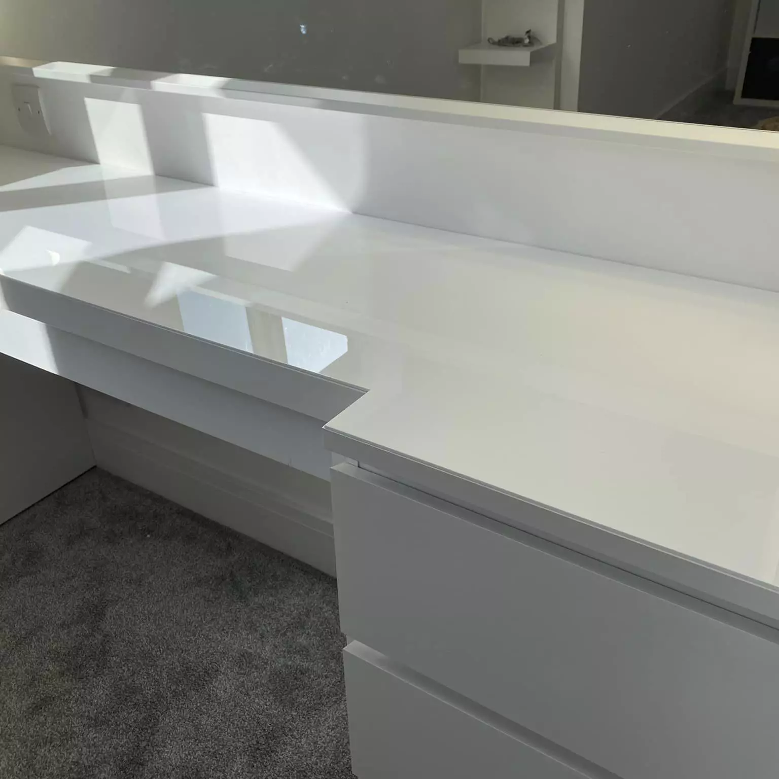 White coloured acrylic table top protector on a dressing table