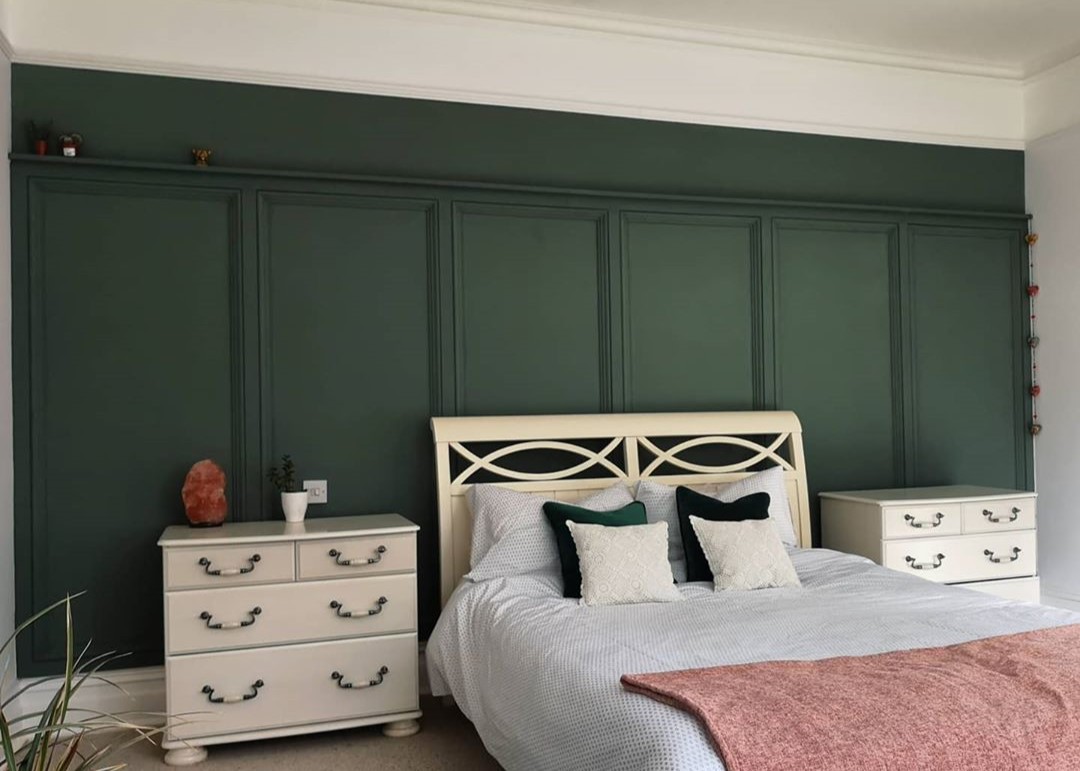 green traditional wall panels in bedroom