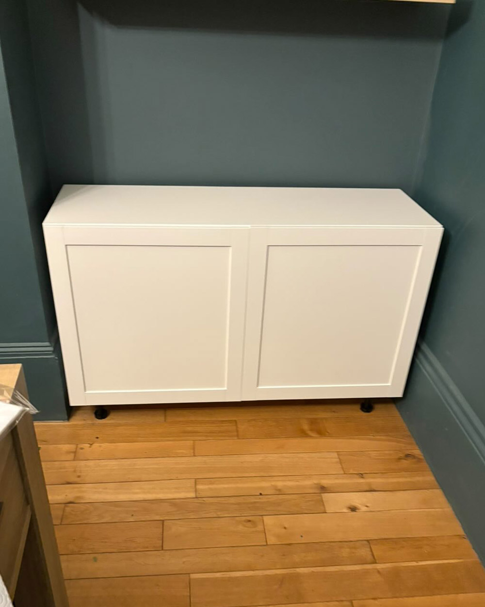 Original white IKEA Besta cabinets placed in the alcove before adding MDF panels and beginning the built-in hack
