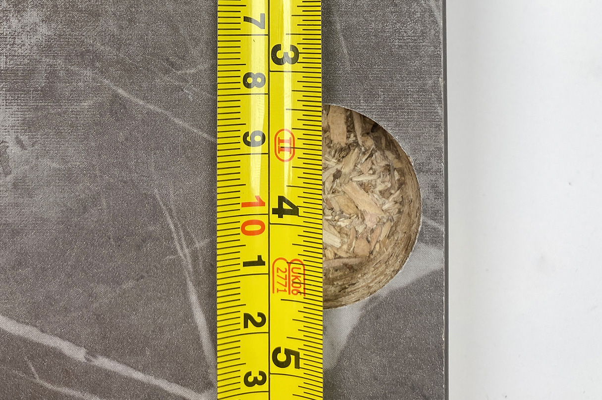Measuring for hinge holes in a kitchen cabinet