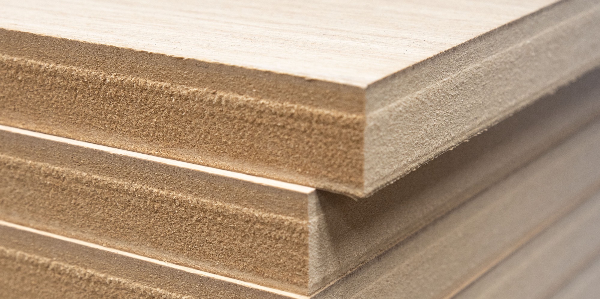 White wall with dark thick plywood shelves